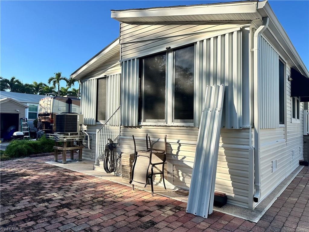 View of property exterior with a central AC unit