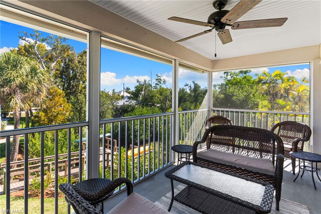 Sunroom featuring ceiling fan, healthy amount of natural light, and a balcony