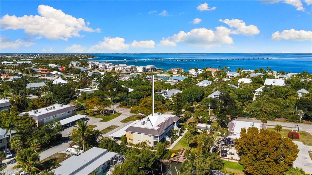 Aerial view of property and surrounding area featuring a nearby body of water