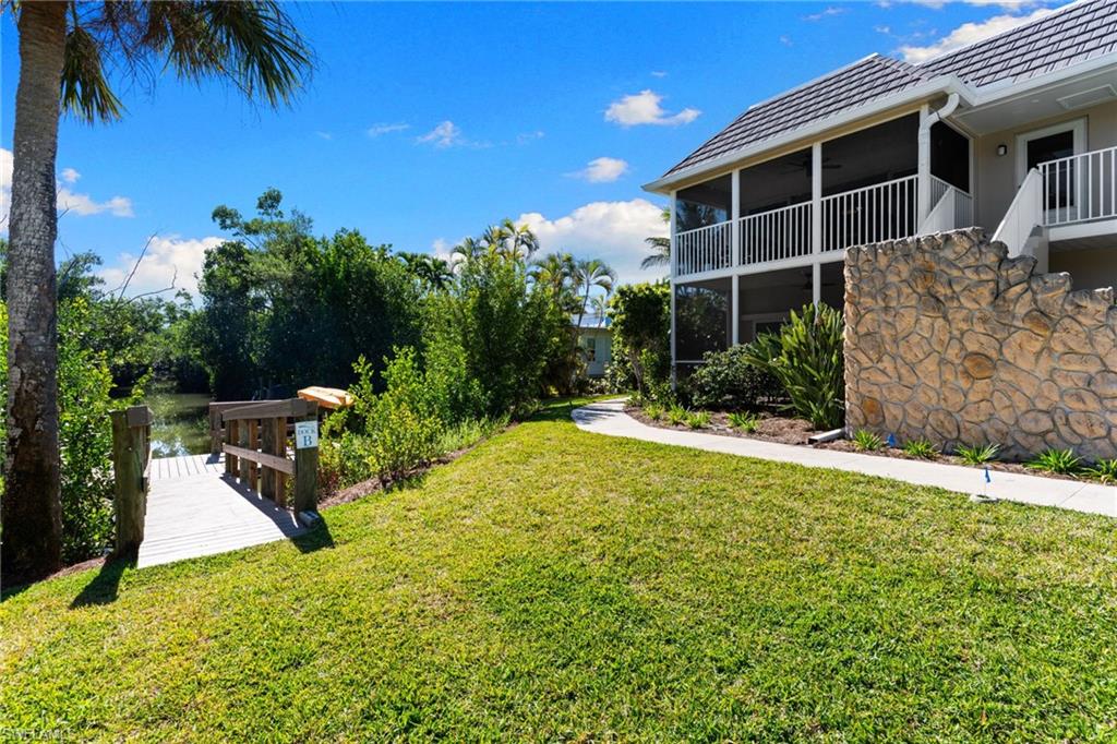 View of home's community featuring a lawn and a sunroom