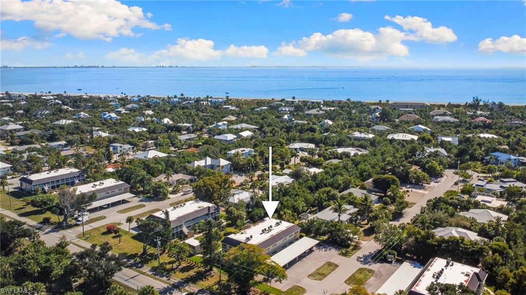 Aerial overview of property's location featuring a large body of water and nearby suburban area