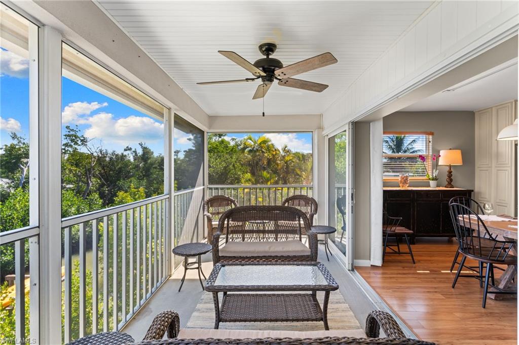 Sunroom with ceiling fan, an outdoor hangout area, and a balcony