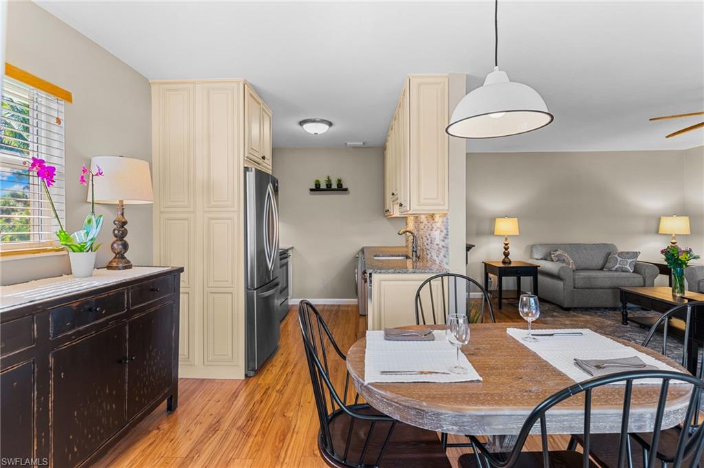 Dining room with a ceiling fan and light wood-style flooring