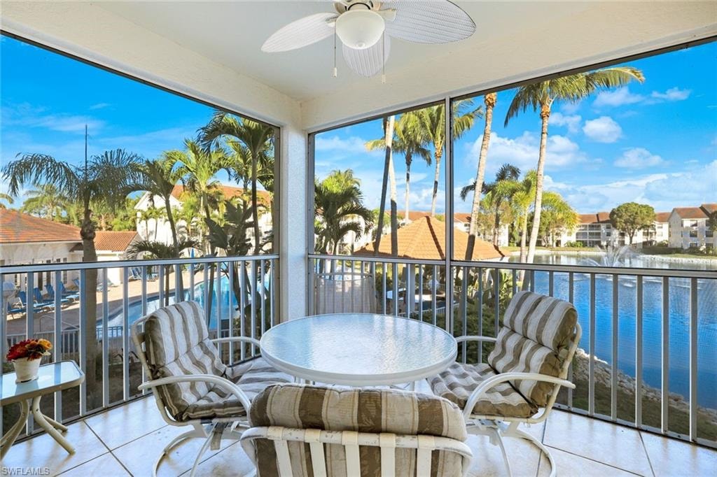 Sunroom / solarium featuring a water view and tile patterned flooring