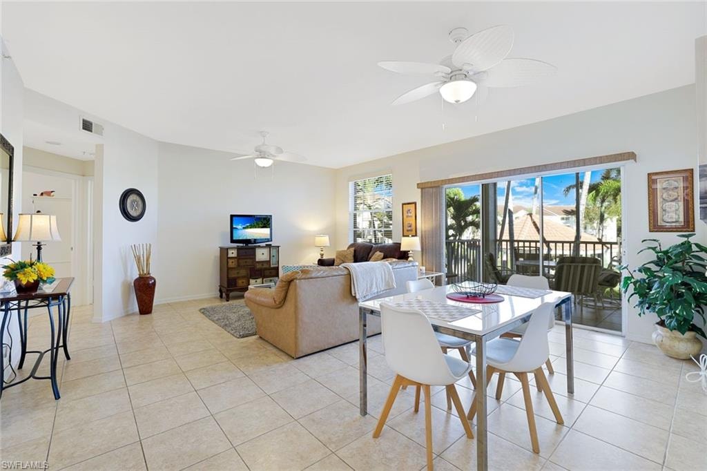 Dining area with a ceiling fan and light tile patterned floors