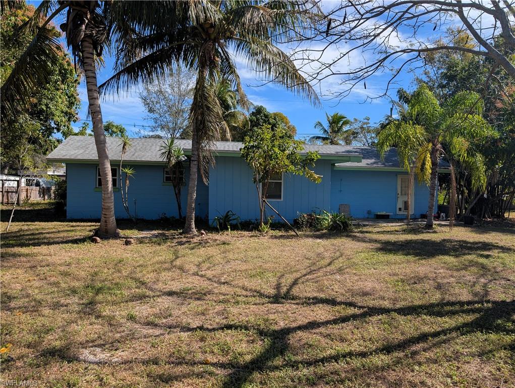 View of side of home with a yard