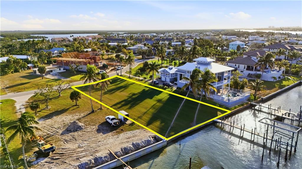 Aerial view of residential area with property boundaries highlighted and a large body of waterchange color of water into natural dark blue canal water