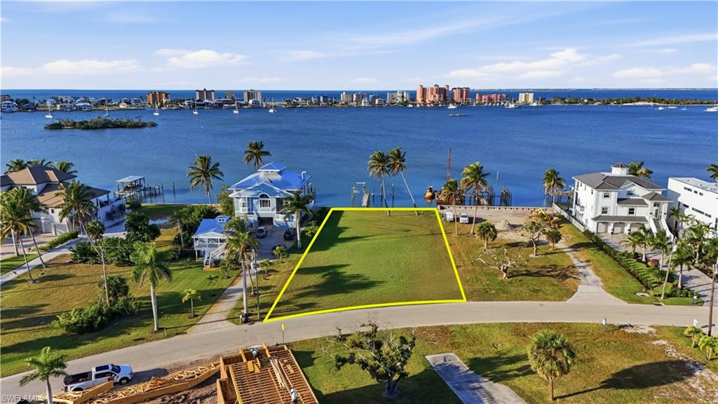 View of urban area with a nearby body of water and property boundaries highlightedchange color of water into natural dark blue canal water