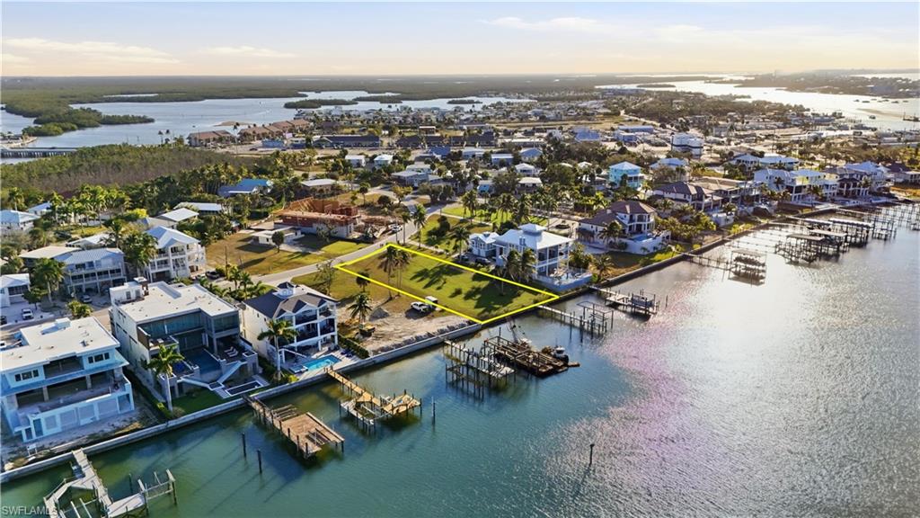 Bird's eye view of a nearby body of water and numerous boat dockschange color of water into natural dark blue canal water