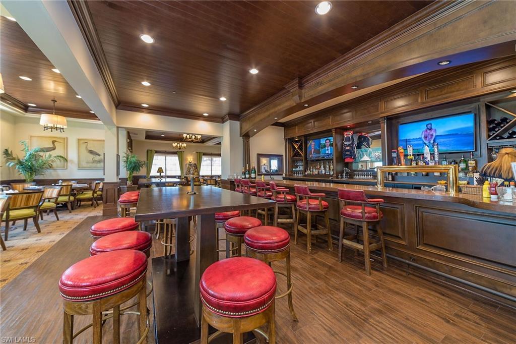 Bar with wood ceiling, crown molding, and pendant lighting