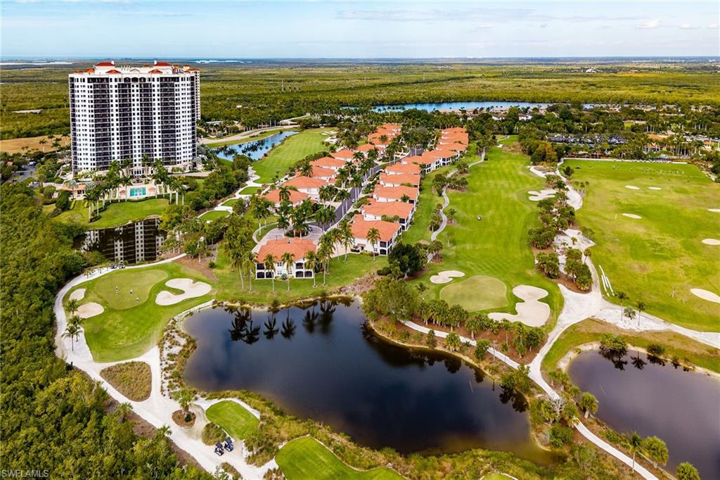 Aerial view of property's location featuring a nearby body of water and a local golf course