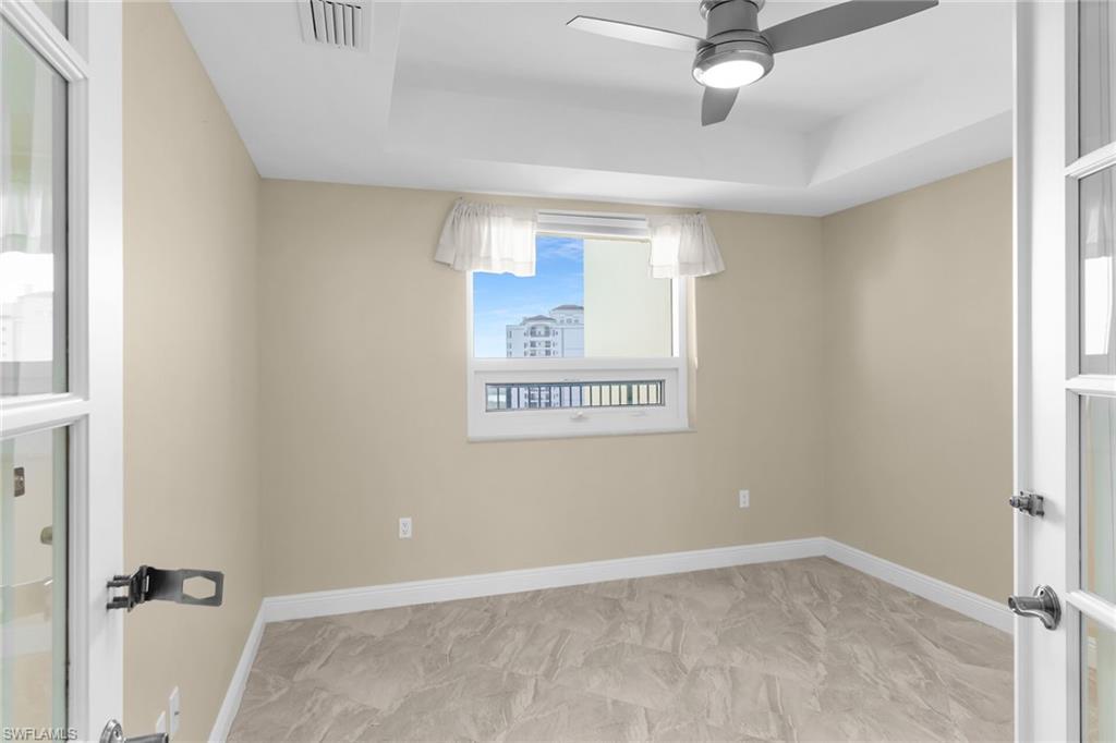 Unfurnished room featuring baseboards and a ceiling fan