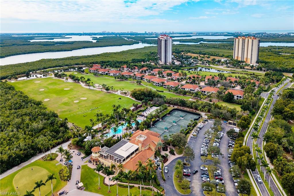 Aerial view of property's location with a large body of water and a golf course