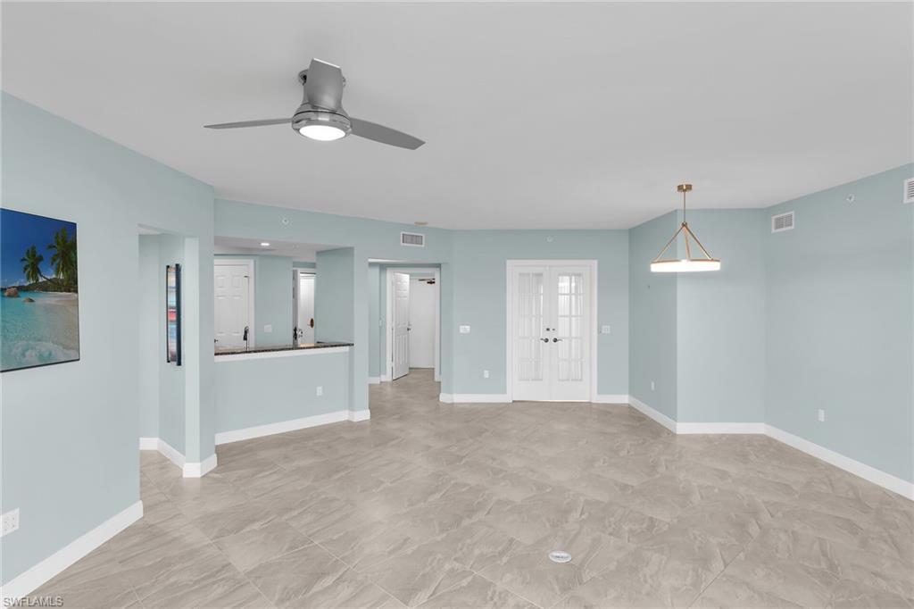 Unfurnished living room with french doors and a ceiling fan