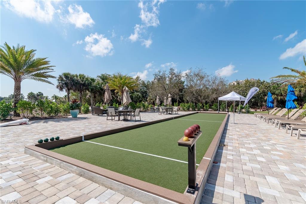 View of property's community featuring a bocce ball area and a patio