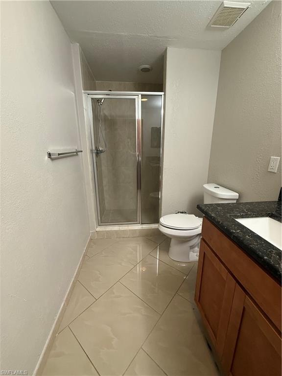 Bathroom with a textured wall, a textured ceiling, vanity, and a shower stall