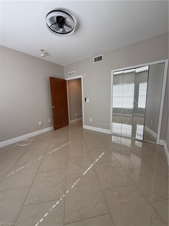 Unfurnished bedroom featuring baseboards and a closet