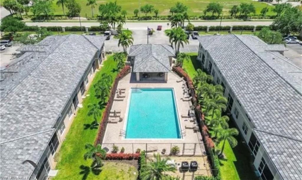 Aerial view of property and surrounding area featuring a pool area