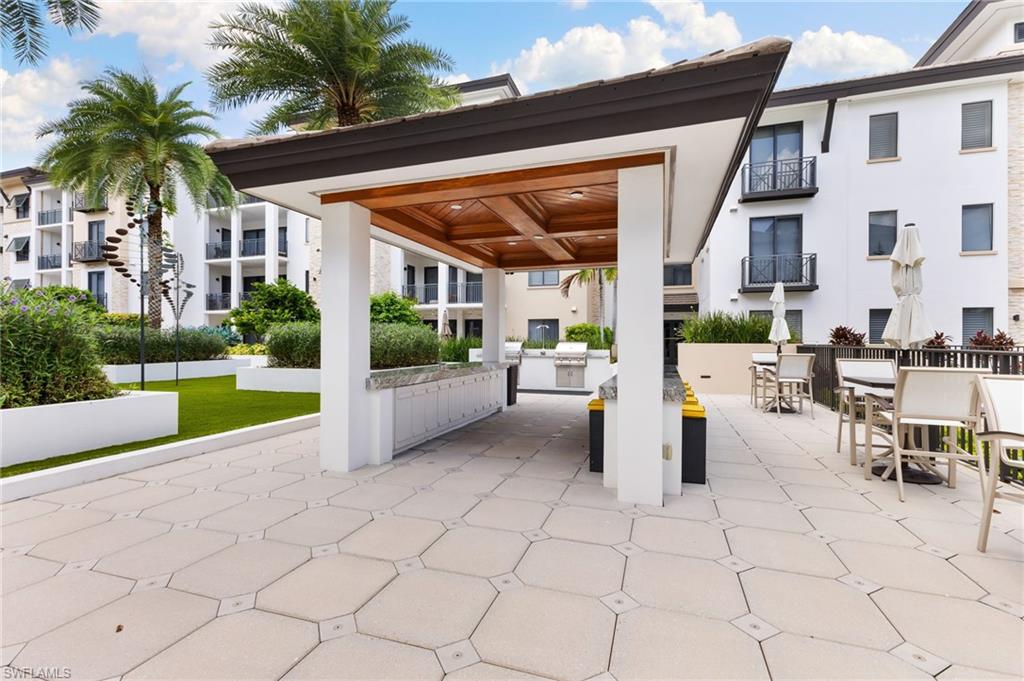View of patio with exterior kitchen and outdoor dining space