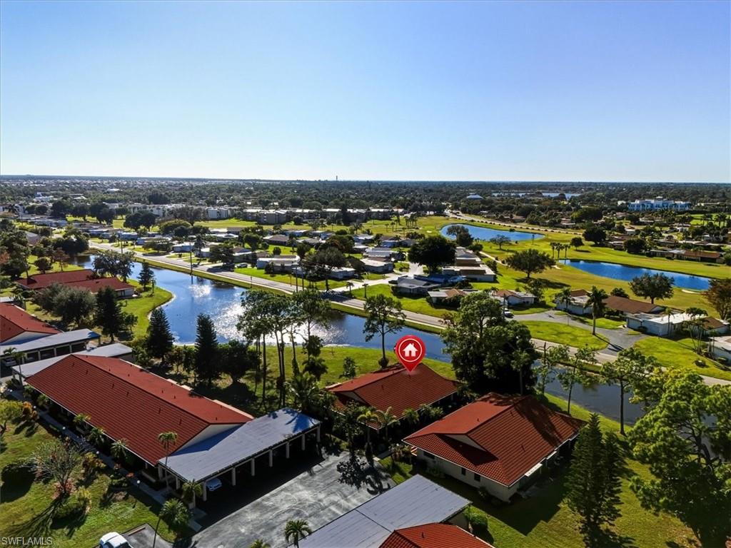Aerial perspective of suburban area featuring a nearby body of water