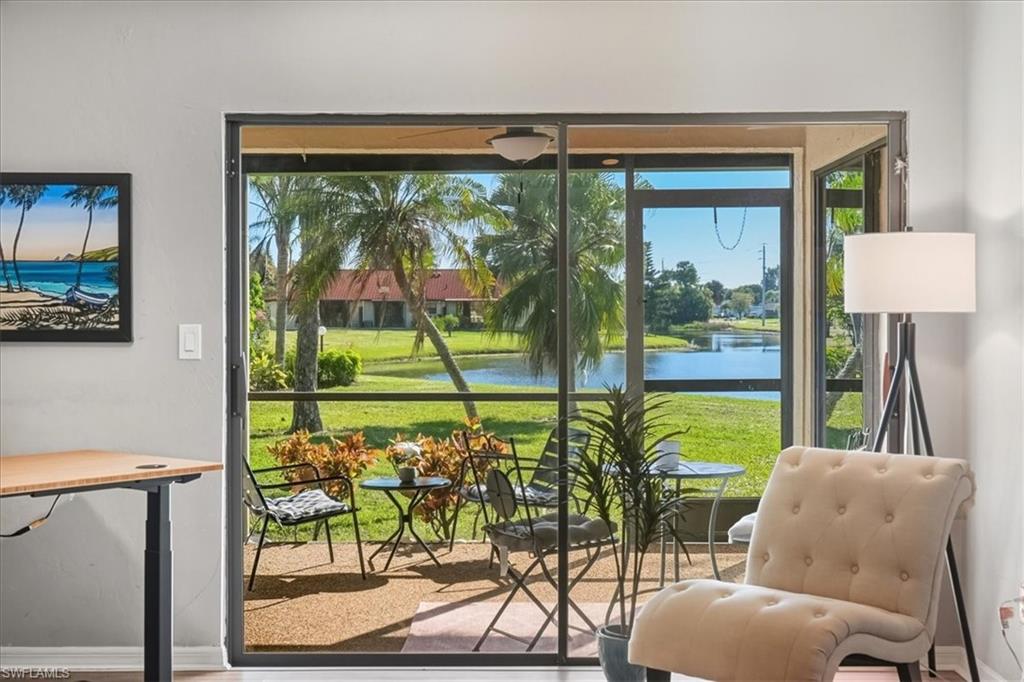 Doorway to outside with a water view and healthy amount of natural light
