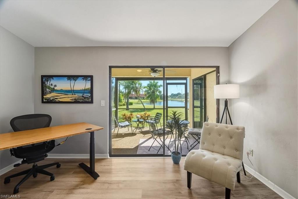 Office area featuring light wood-style flooring and a water view