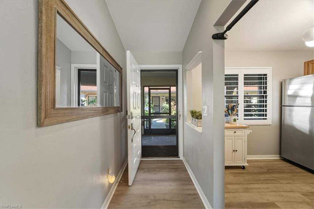 Hall featuring baseboards and light wood-style flooring