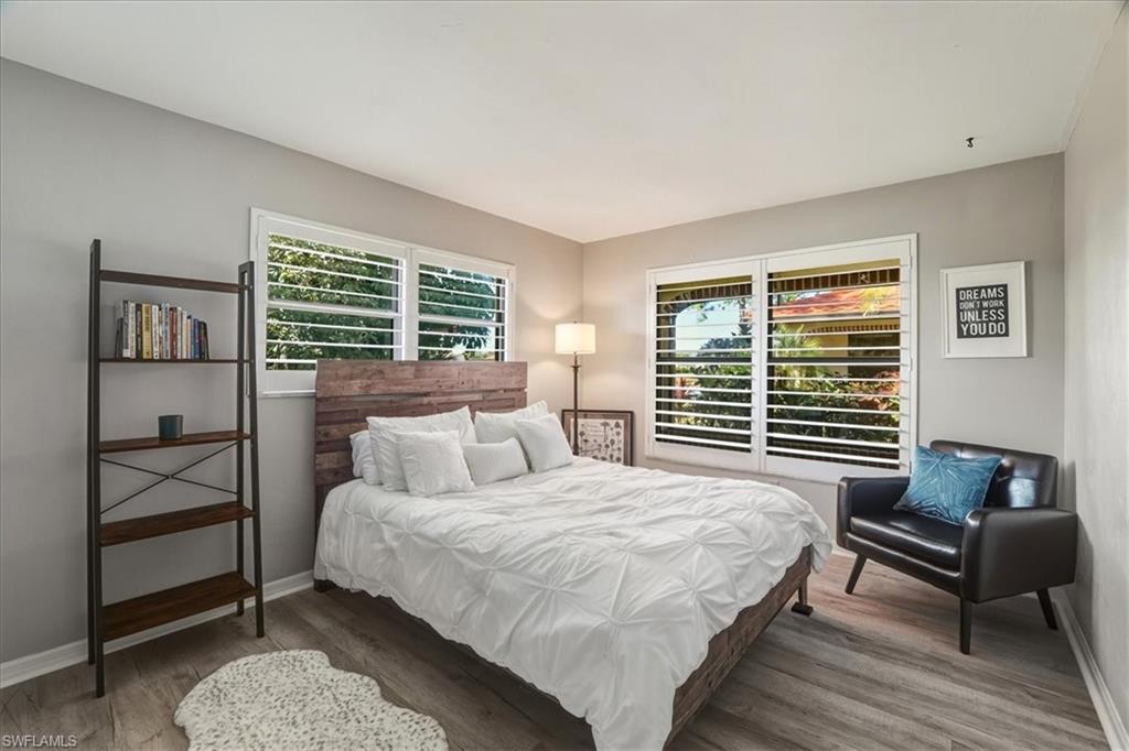 Bedroom with wood finished floors and baseboards