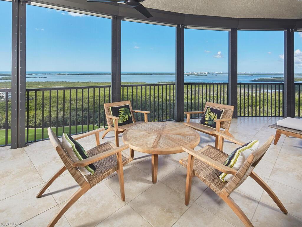 Sunroom / solarium featuring a water view, floor to ceiling windows, and tile patterned flooring