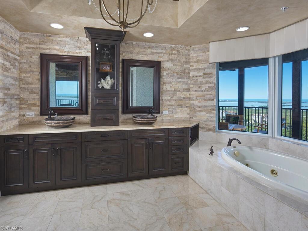 Bathroom featuring a whirlpool tub and double vanity
