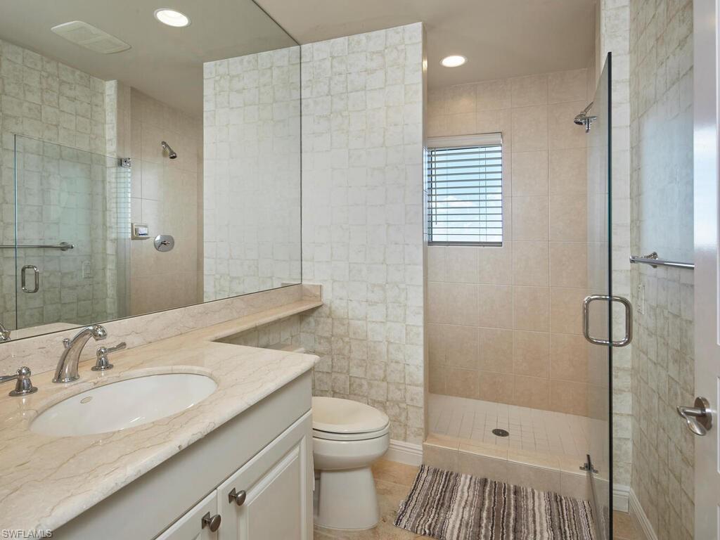 Full bath with vanity, a shower stall, recessed lighting, and light tile patterned flooring