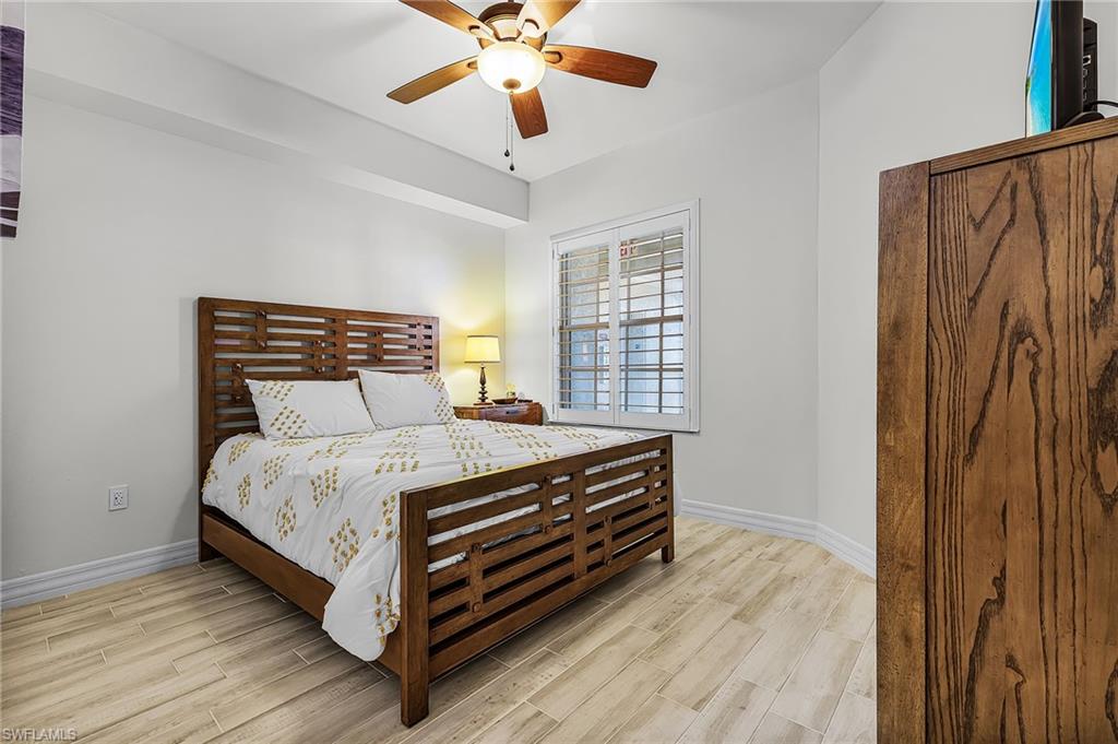 Guest bedrm with queen size bed and dresser.