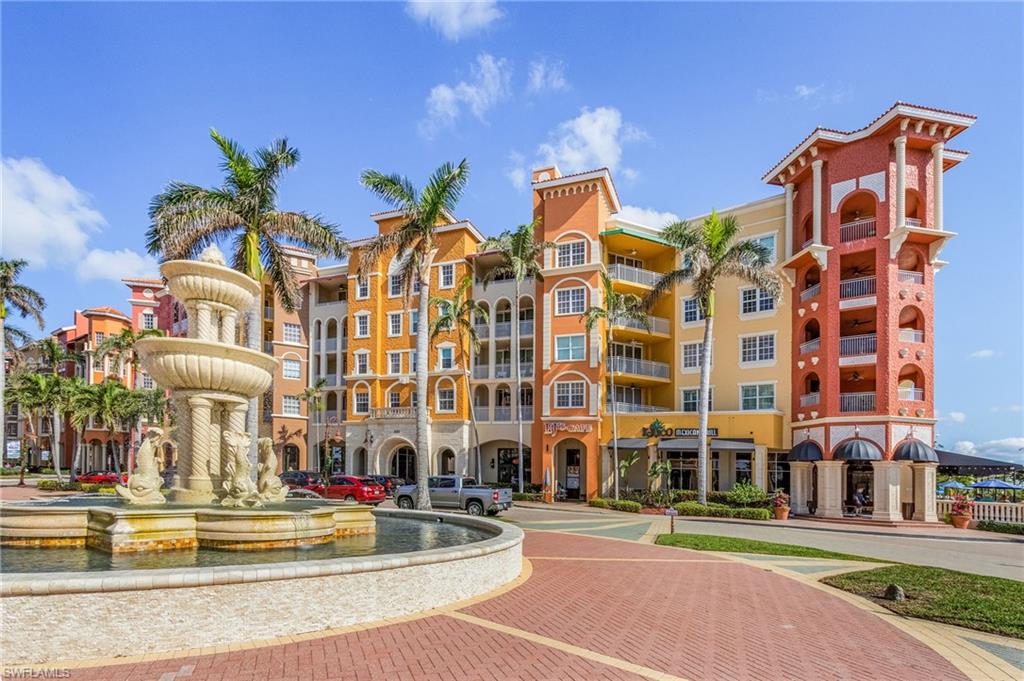 Colorful  architecture with waterfront boardwalk, brick paved pathways and sunlit fountains