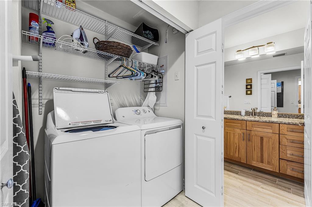 Washroom featuring wood tiled floors and separate washer and dryer