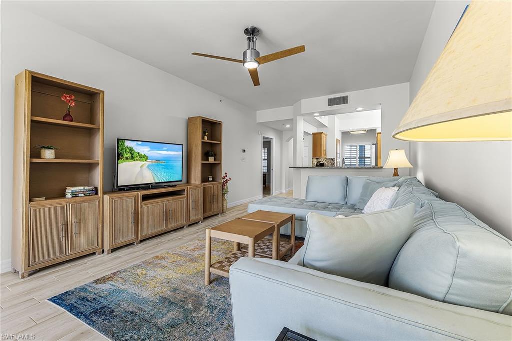 Living room with a ceiling fan and wood tile finish floors