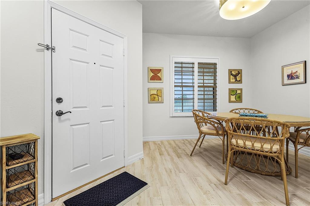 Dining room with light wood-type porcelain flooring.