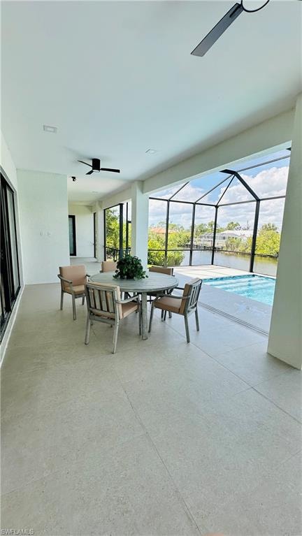 Expansive screened lanai featuring a swimming pool, waterfront access, and recessed lighting