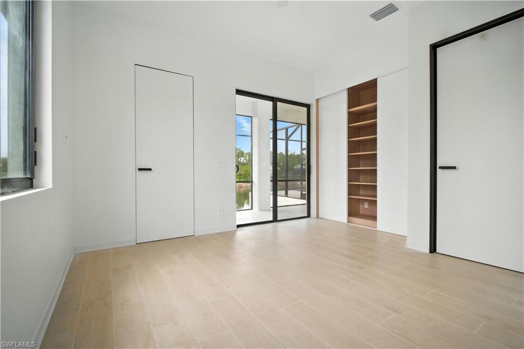 Unfurnished bedroom featuring access to outside and light wood finished floors