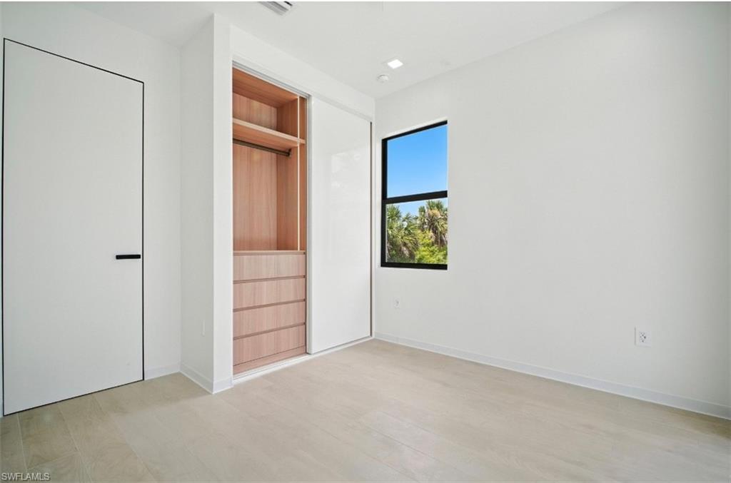 Unfurnished bedroom featuring light wood-style flooring and baseboards