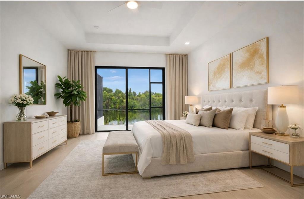 Bedroom featuring access to outside, a raised ceiling, ceiling fan, a water view, and recessed lighting (Rendered photo)