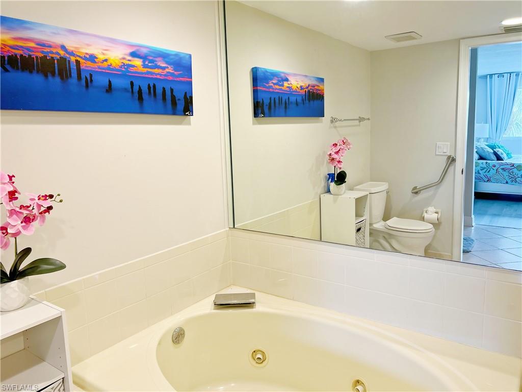Full bathroom featuring a tub with jets and ensuite bath