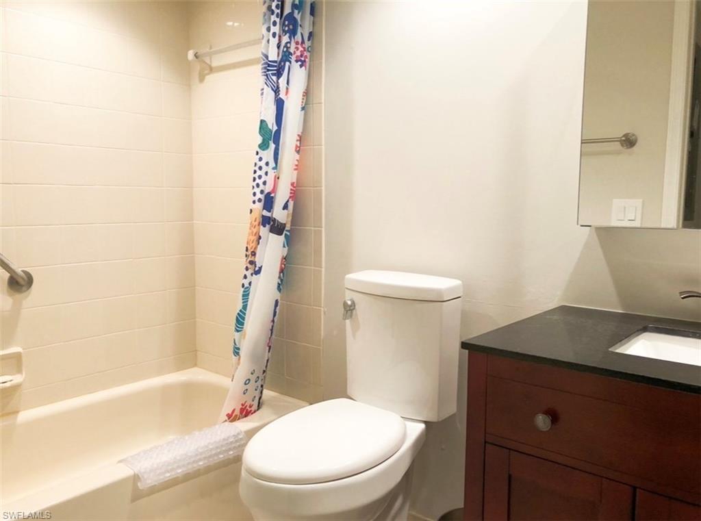 Full bath with vanity and shower / bath combo with shower curtain