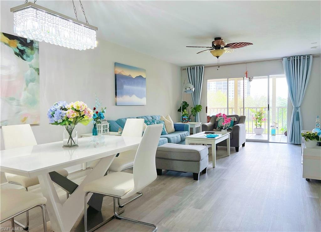 Living room with light wood finished floors and ceiling fan