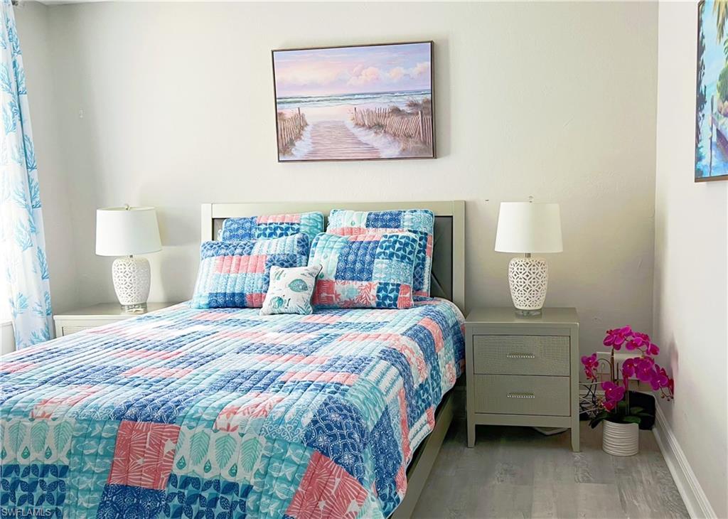 Bedroom featuring baseboards and wood finished floors