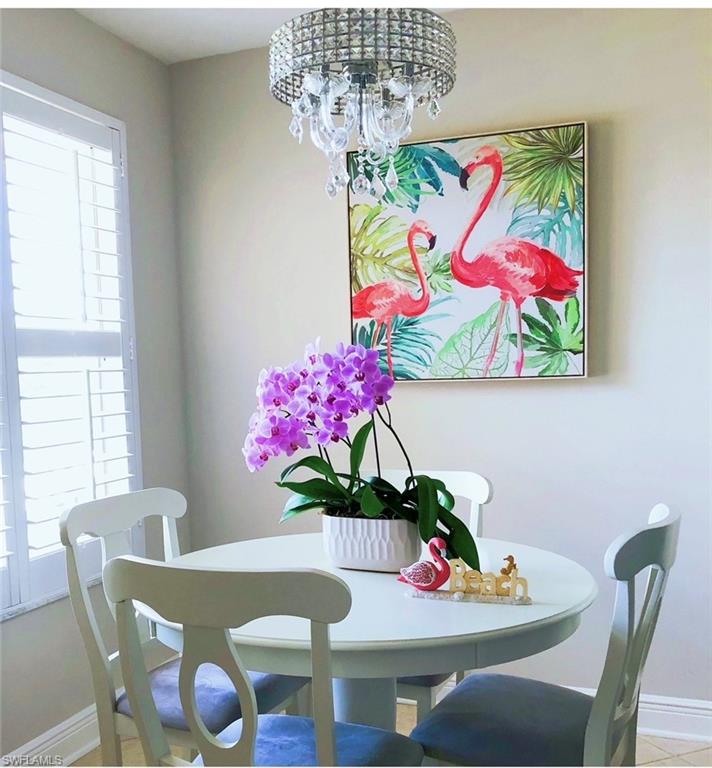 Dining area featuring baseboards and a chandelier