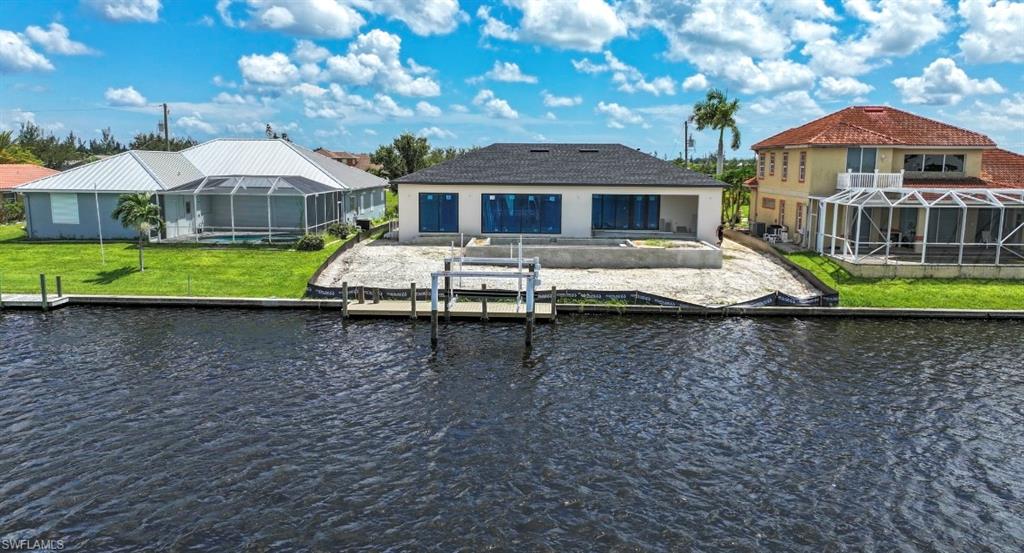 Dock featuring a sunroom, a patio area, and a water view