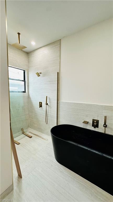 Full bath with a soaking tub and a walk in shower