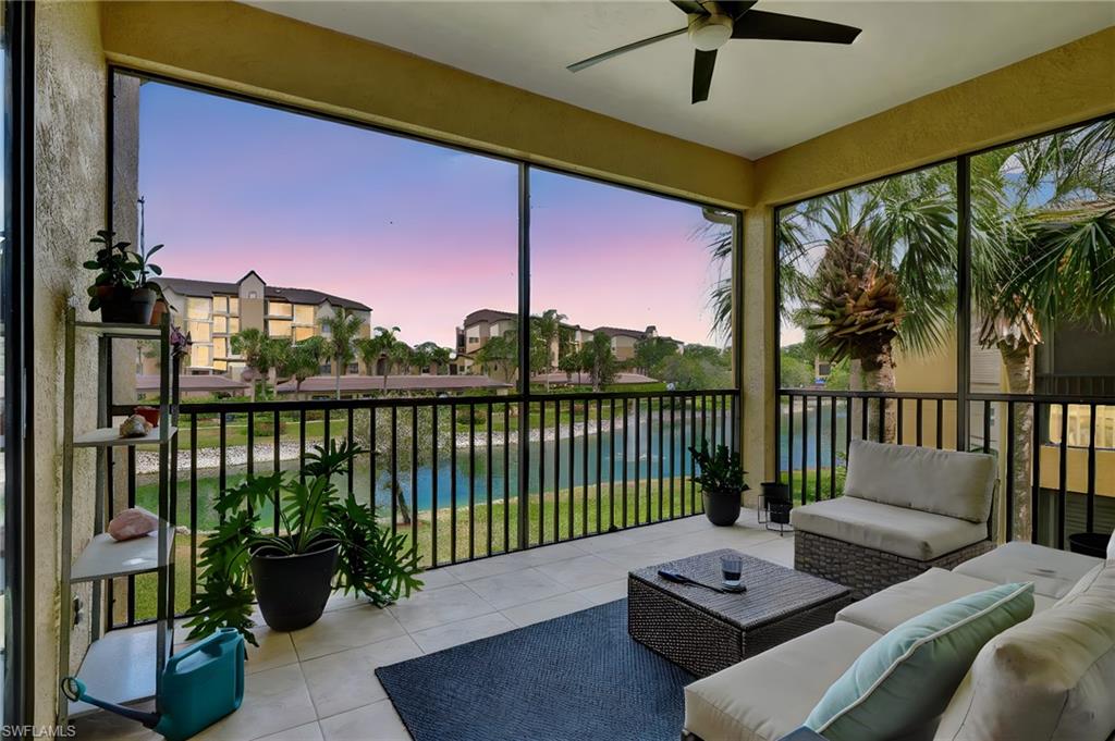 Sunroom featuring a water view