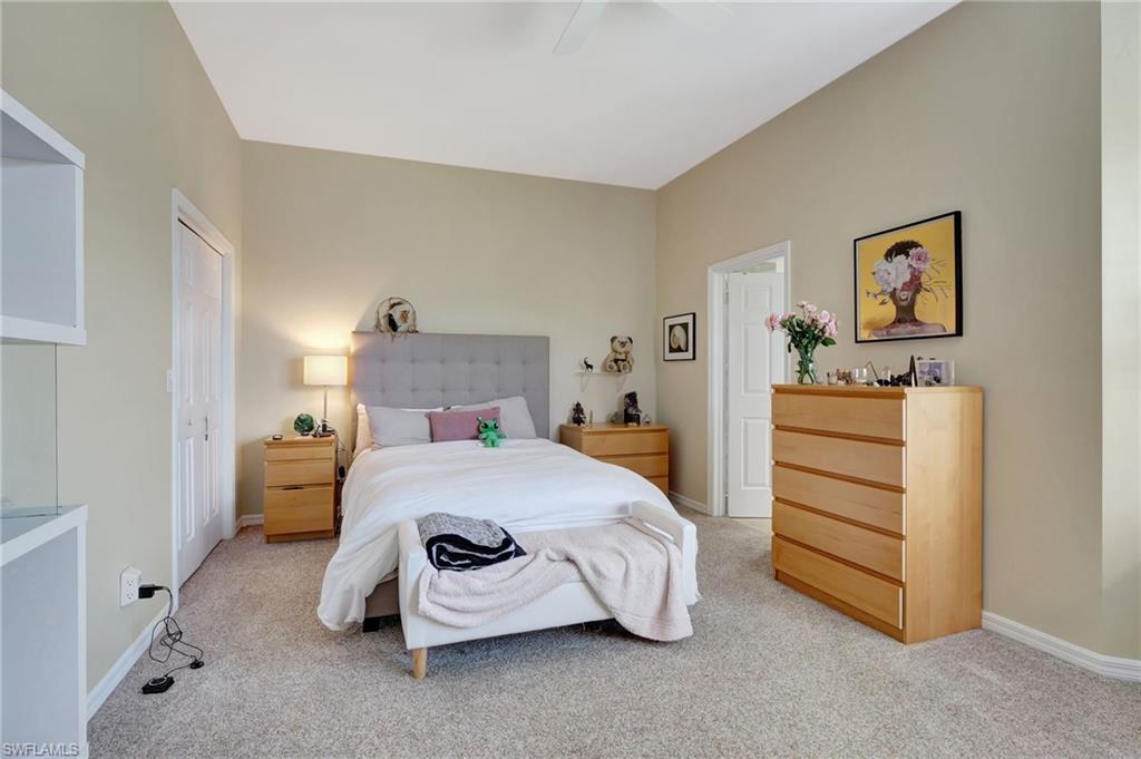 Bedroom featuring baseboards, ceiling fan, and light colored carpet
