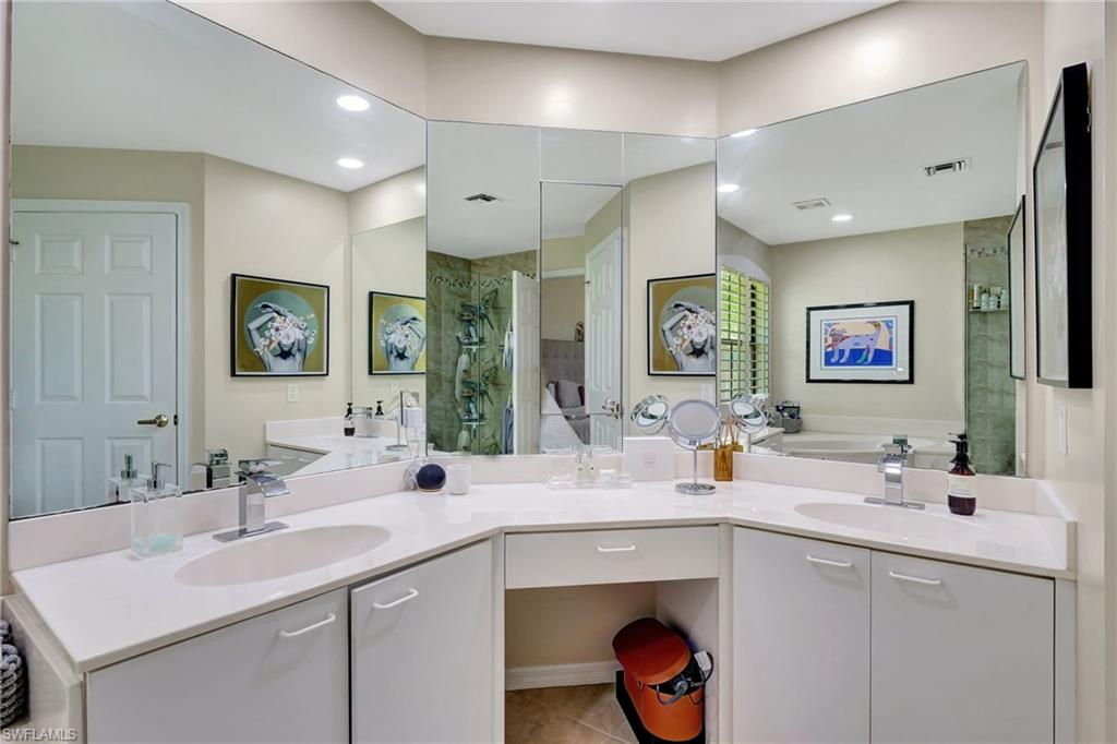 Full bath featuring visible vents, a stall shower, a bath, and a sink